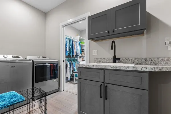 a kitchen with stainless steel appliances granite countertop a sink and cabinets