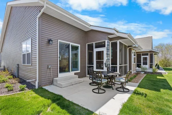a view of a house with yard and sitting area