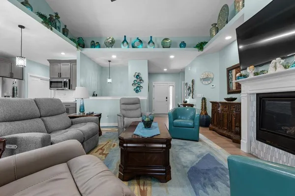 a living room with furniture and a fireplace