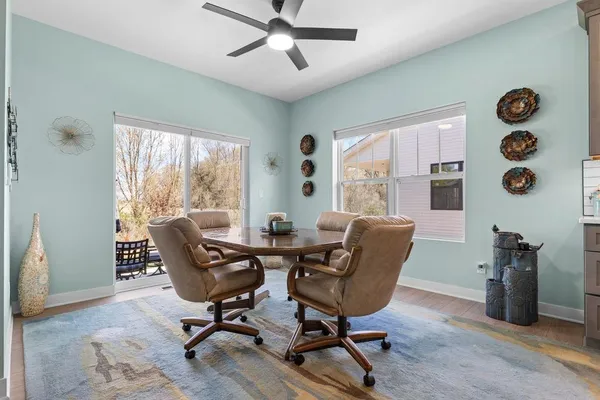 a view of a livingroom with workspace and a window