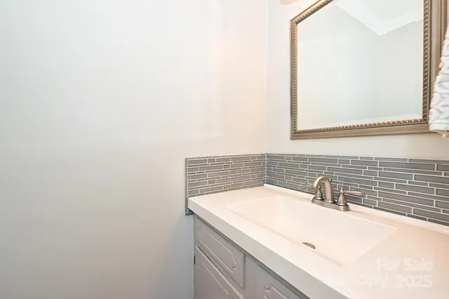 a bathroom with a sink and a white cabinet