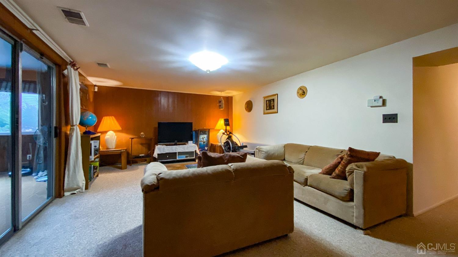61 Stephenville Parkway Edison, NJ 08820 - Photo 11 of 32 a living room with furniture and a flat screen tv