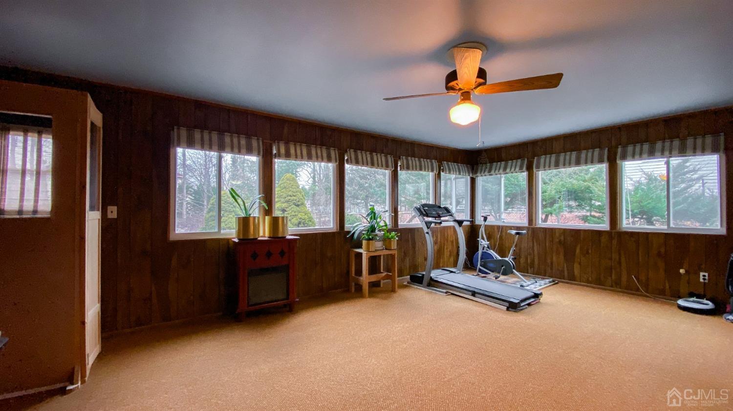 61 Stephenville Parkway Edison, NJ 08820 - Photo 13 of 32 a living room with furniture gym equipment and a large window