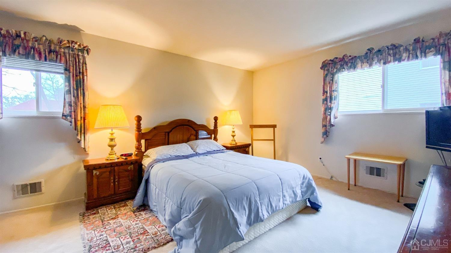 61 Stephenville Parkway Edison, NJ 08820 - Photo 18 of 32 a bedroom with a bed dresser and a window