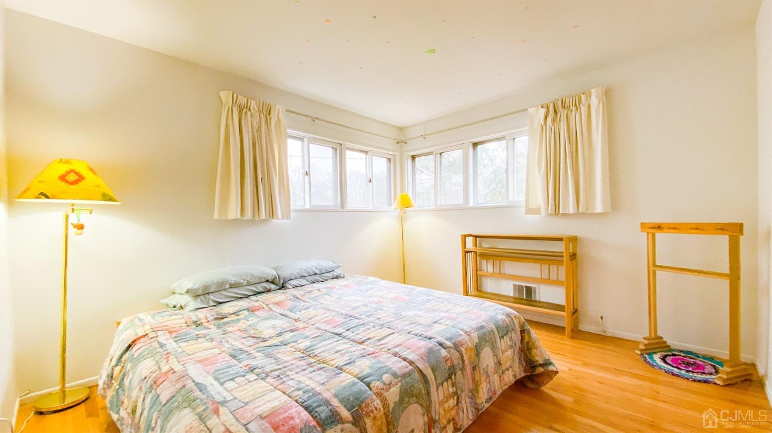 61 Stephenville Parkway Edison, NJ 08820 - Photo 20 of 32 a bedroom with a bed and a dresser