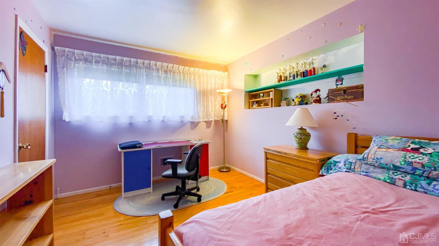 61 Stephenville Parkway Edison, NJ 08820 - Photo 21 of 32 a bedroom with a bed and a table in it