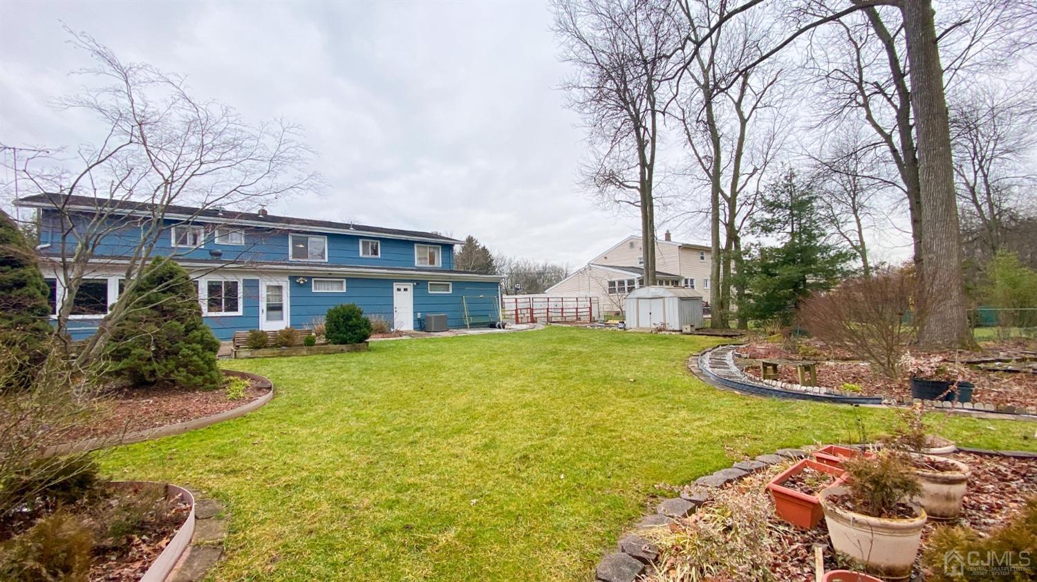 61 Stephenville Parkway Edison, NJ 08820 - Photo 26 of 32 a front view of a house with garden