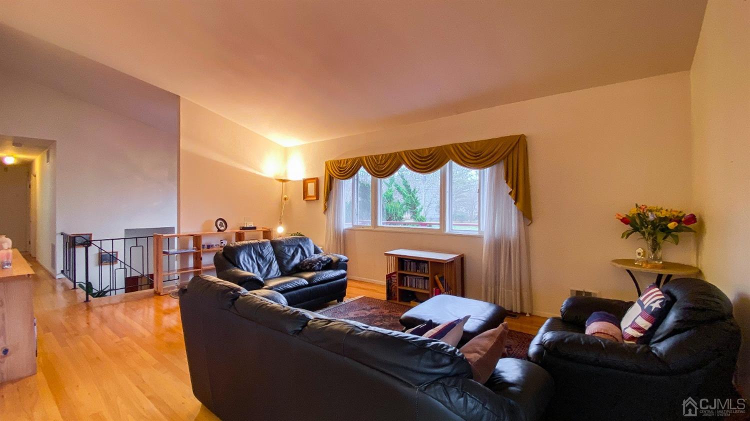 61 Stephenville Parkway Edison, NJ 08820 - Photo 6 of 32 a living room with furniture and a wooden floor