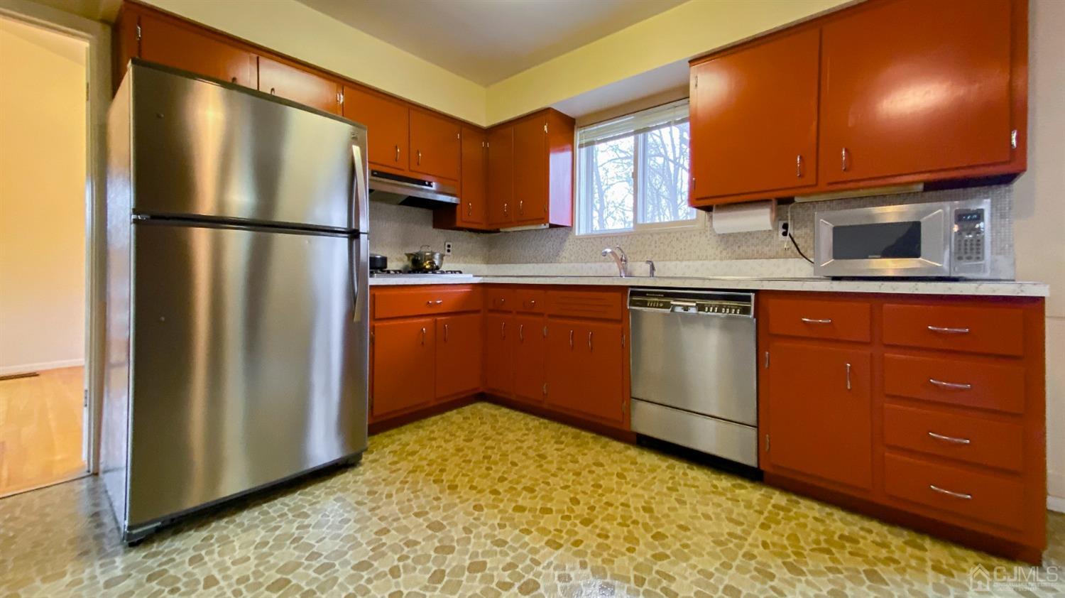 61 Stephenville Parkway Edison, NJ 08820 - Photo 9 of 32 a kitchen with stainless steel appliances granite countertop a refrigerator and a sink