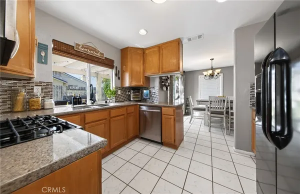 a kitchen with stainless steel appliances a refrigerator sink and cabinets