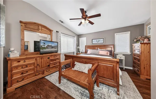 a bedroom with a bed and flat screen tv