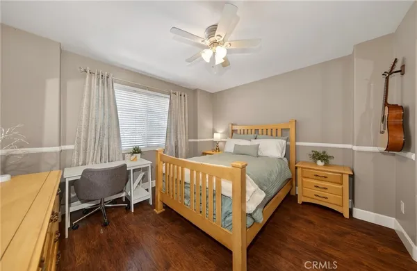 a bedroom with a bed and a chair in it