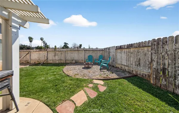 a view of a backyard with plants and outdoor seating