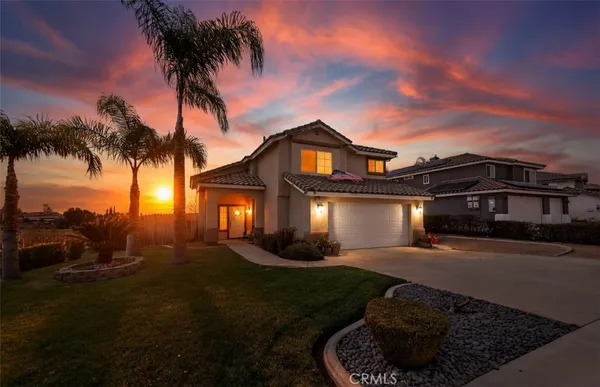 a front view of a house with a garden and yard