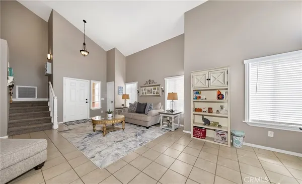 a living room with furniture and a book shelf