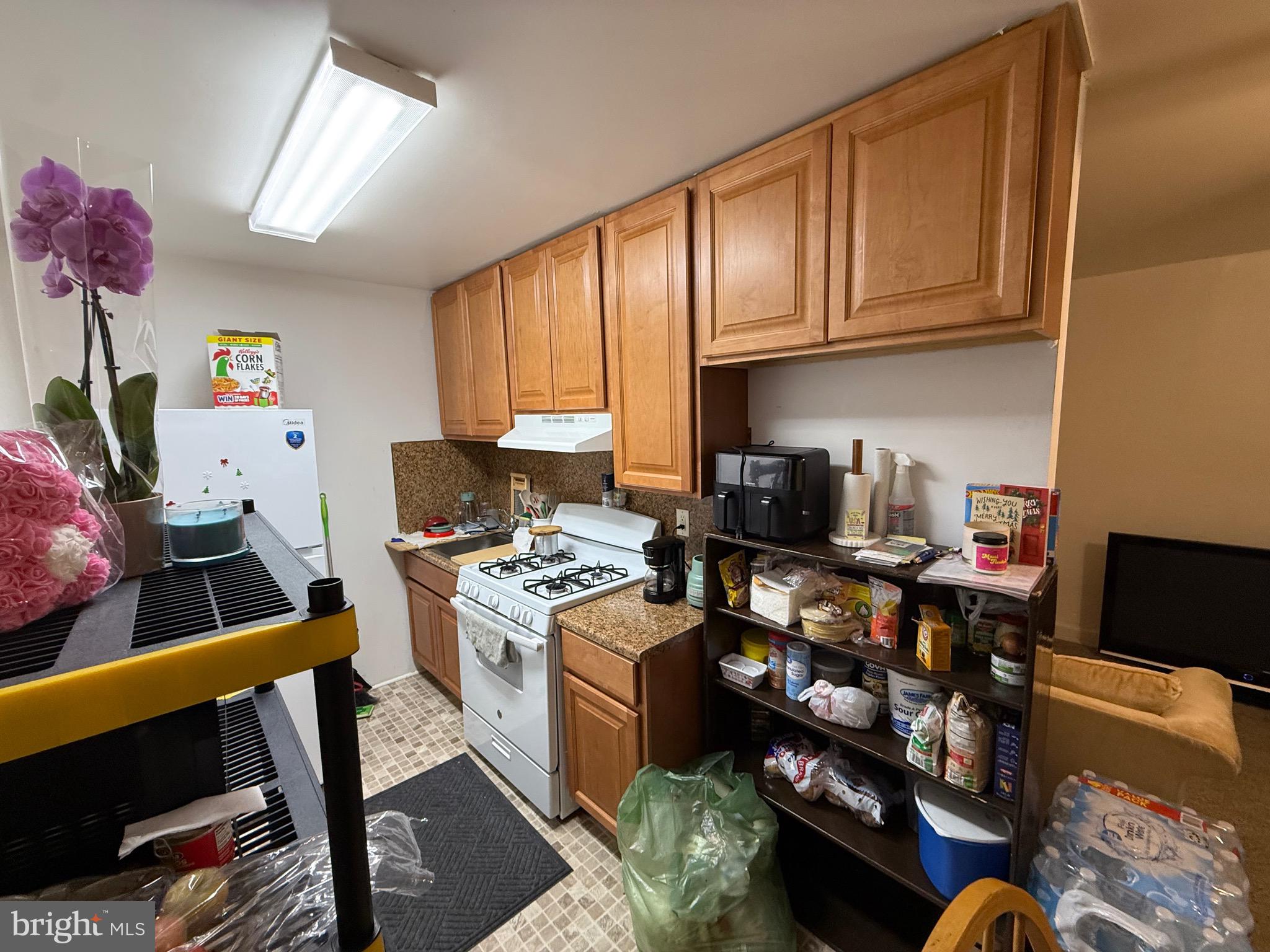2112 Seneca Road Wilmington, DE 19805 - Photo 13 of 26 a kitchen with stainless steel appliances granite countertop a stove refrigerator and cabinets