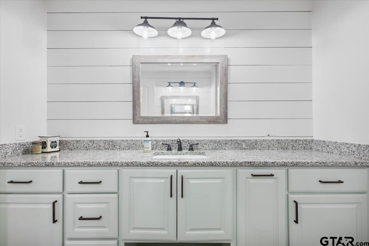 9235 Farm To Market Road 851 Rusk, TX 75785 - Photo 35 of 47 a bathroom with a granite countertop sink and a mirror
