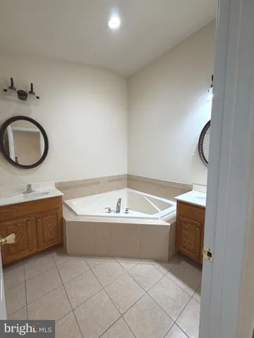 a bathroom with a tub a sink and a shower