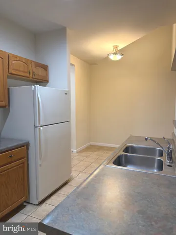 a bathroom with a sink and refrigerator