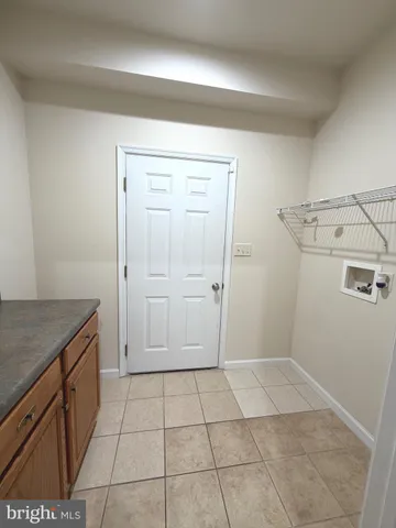 a view of a storage and utility room with a sink