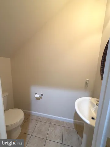 a white toilet sitting next to a shower