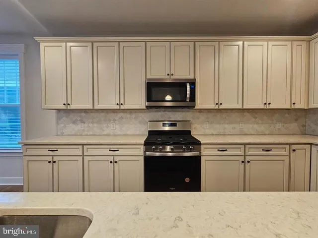 a view of a kitchen center a sink and a counter top space