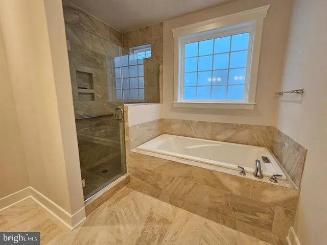 a bathroom with a bathtub and shower