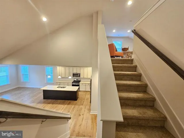 a large kitchen with stainless steel appliances granite countertop a stove a sink and a refrigerator