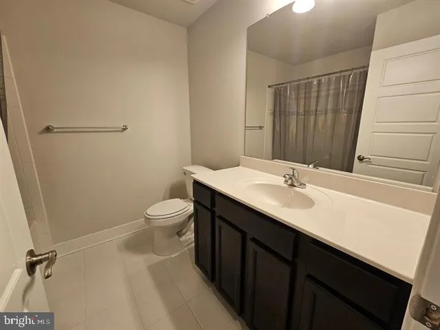 a bathroom with a sink vanity and a mirror