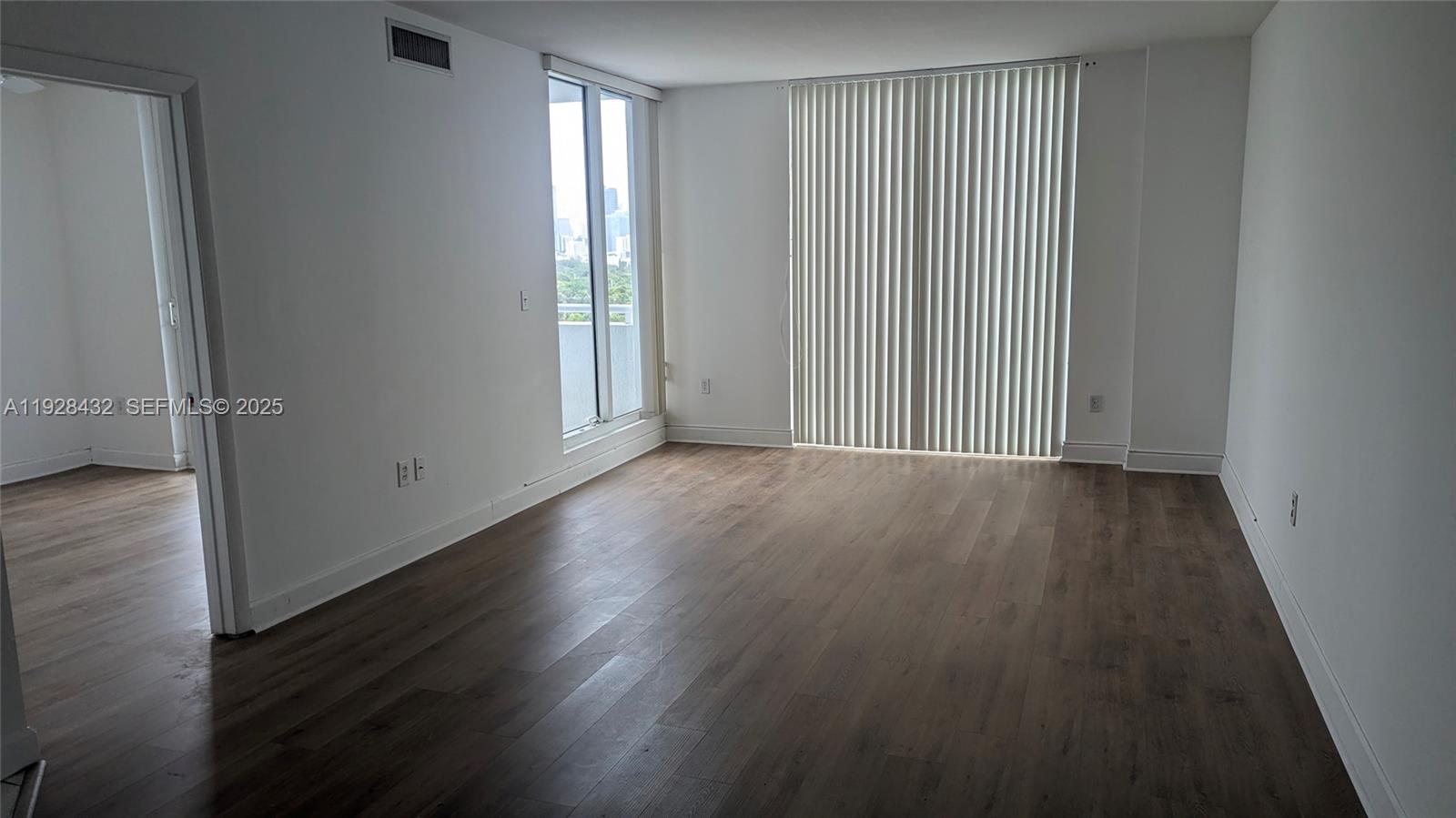 1401 Southwest 22nd Street, Unit 1405 Miami, FL 33145 - Photo 4 of 13 an empty room with wooden floor and windows