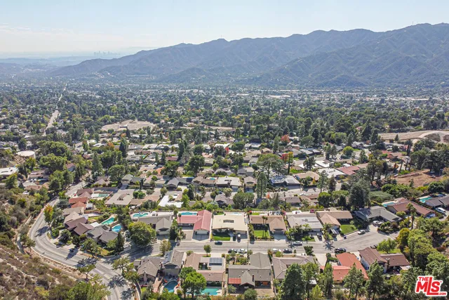an aerial view of residential houses and city view