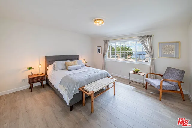 a bedroom with a bed and a chair