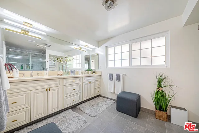 a bathroom with a tub sink and mirror
