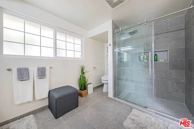 a bathroom with a shower and a window