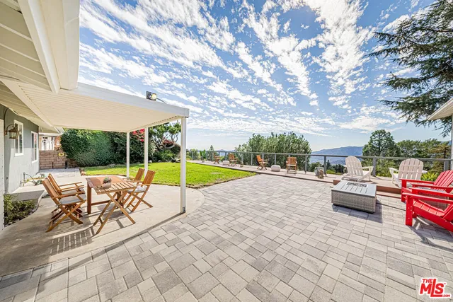 a view of swimming pool with lounge chair and dinning table under an umbrella