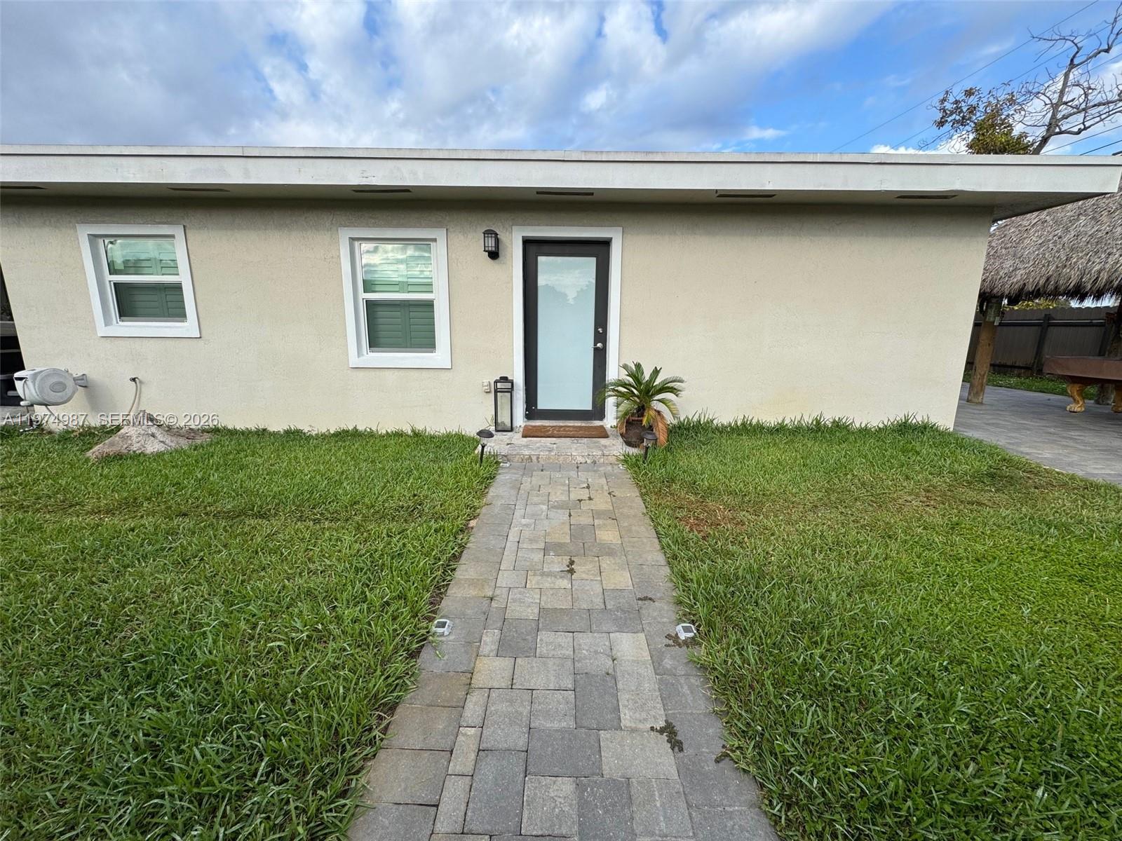 a front view of a house with a garden