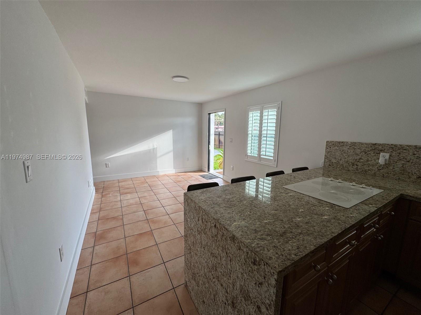 211 West 33rd Street, Unit 2 Hialeah, FL 33012 - Photo 5 of 9 a kitchen with a granite countertop sink and granite counter tops