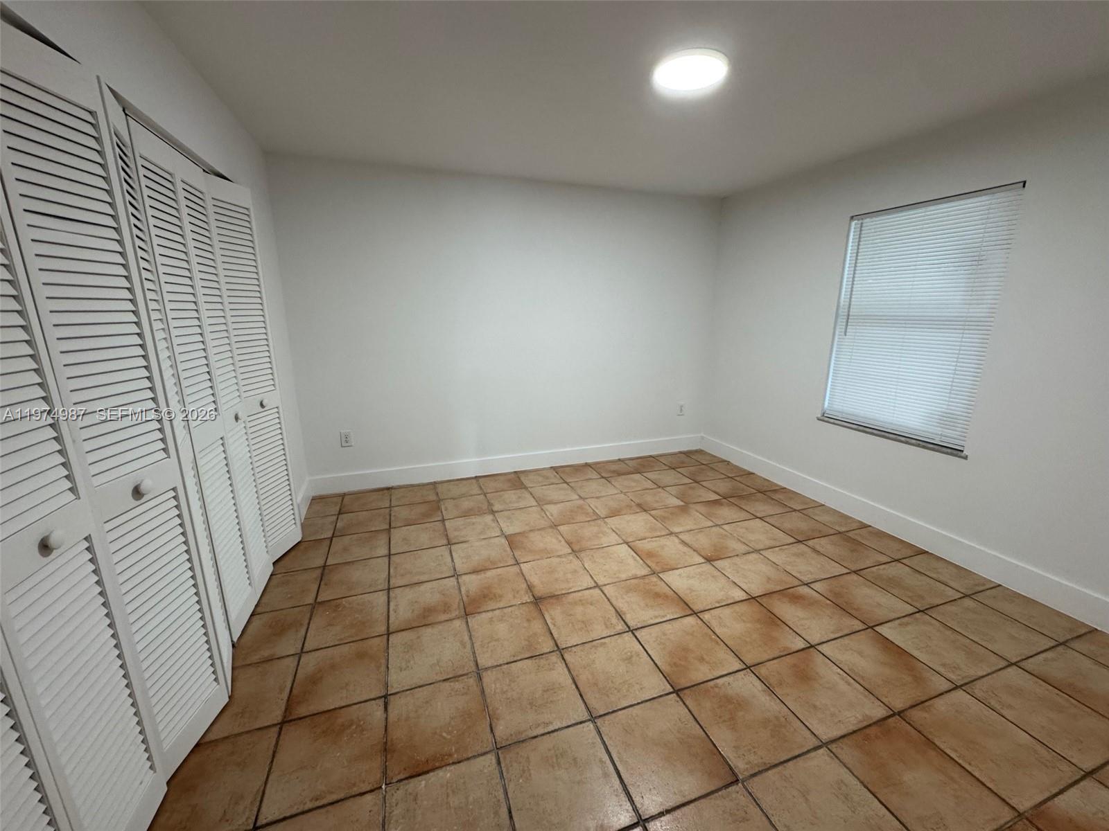 211 West 33rd Street, Unit 2 Hialeah, FL 33012 - Photo 7 of 9 an empty room with white walls