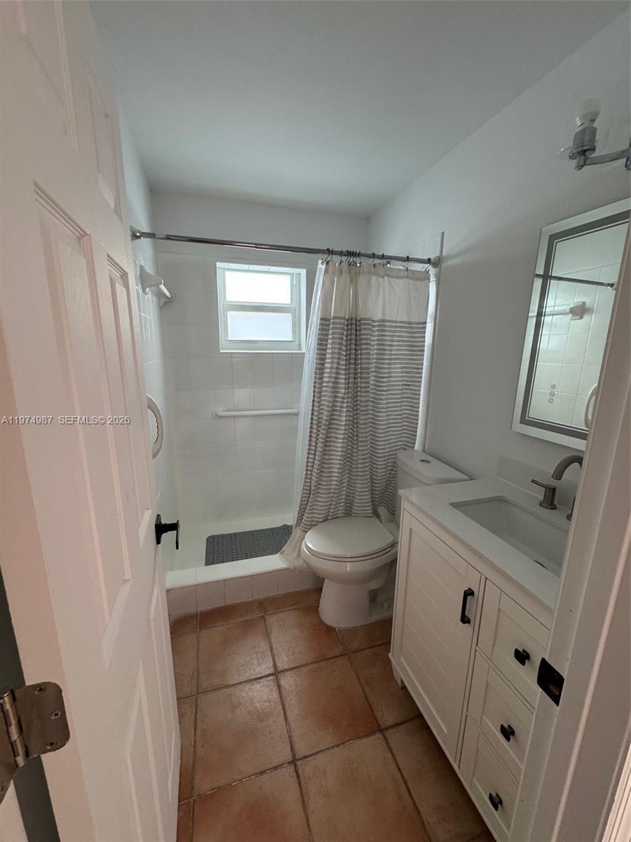 211 West 33rd Street, Unit 2 Hialeah, FL 33012 - Photo 8 of 9 a bathroom with a granite countertop sink toilet and shower