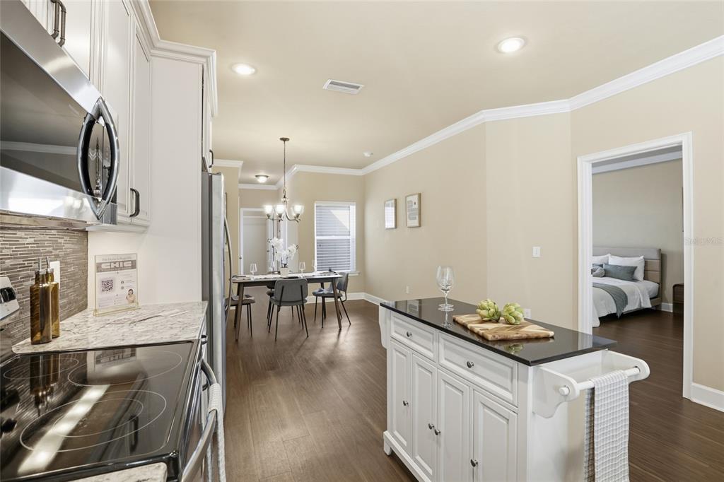 7894 Southwest 80th Drive Gainesville, FL 32608 - Photo 14 of 31 a kitchen with granite countertop a stove and white cabinets