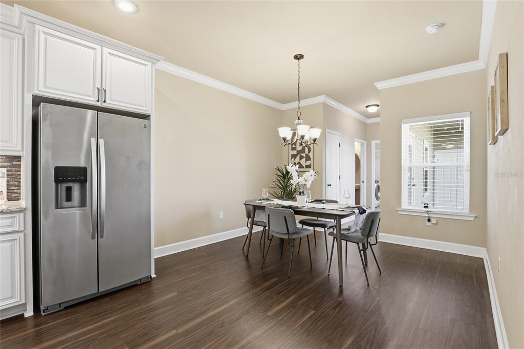 7894 Southwest 80th Drive Gainesville, FL 32608 - Photo 15 of 31 a view of a dining room with furniture window and wooden floor