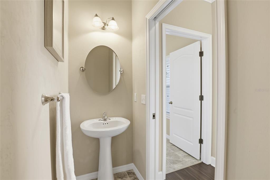 7894 Southwest 80th Drive Gainesville, FL 32608 - Photo 16 of 31 a bathroom with a sink a mirror and a shower