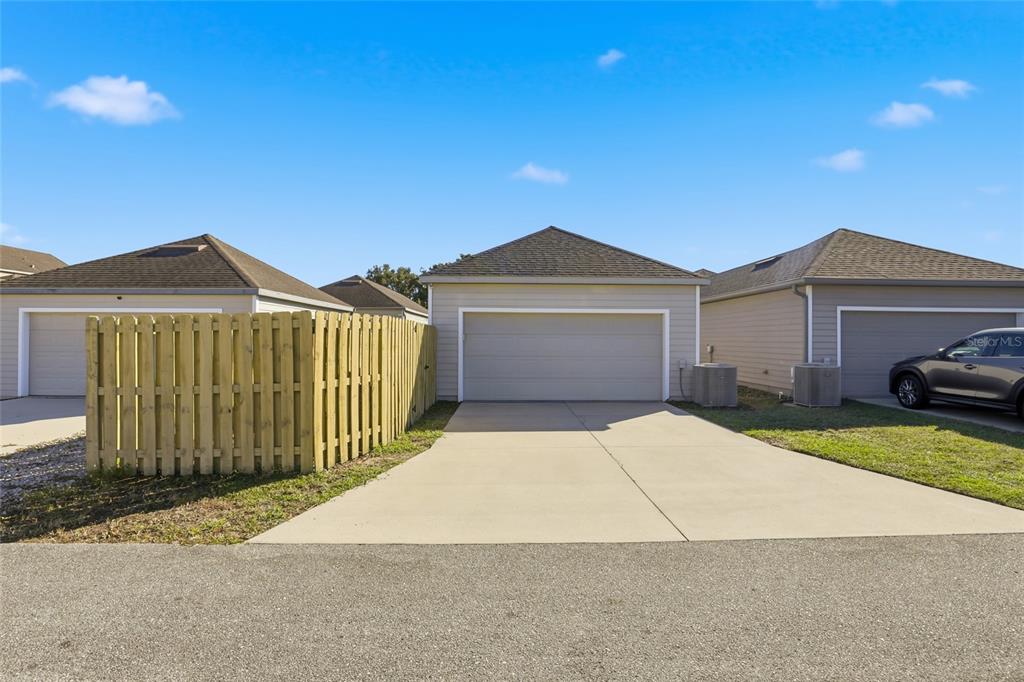 7894 Southwest 80th Drive Gainesville, FL 32608 - Photo 28 of 31 a front view of a house with a yard and garage