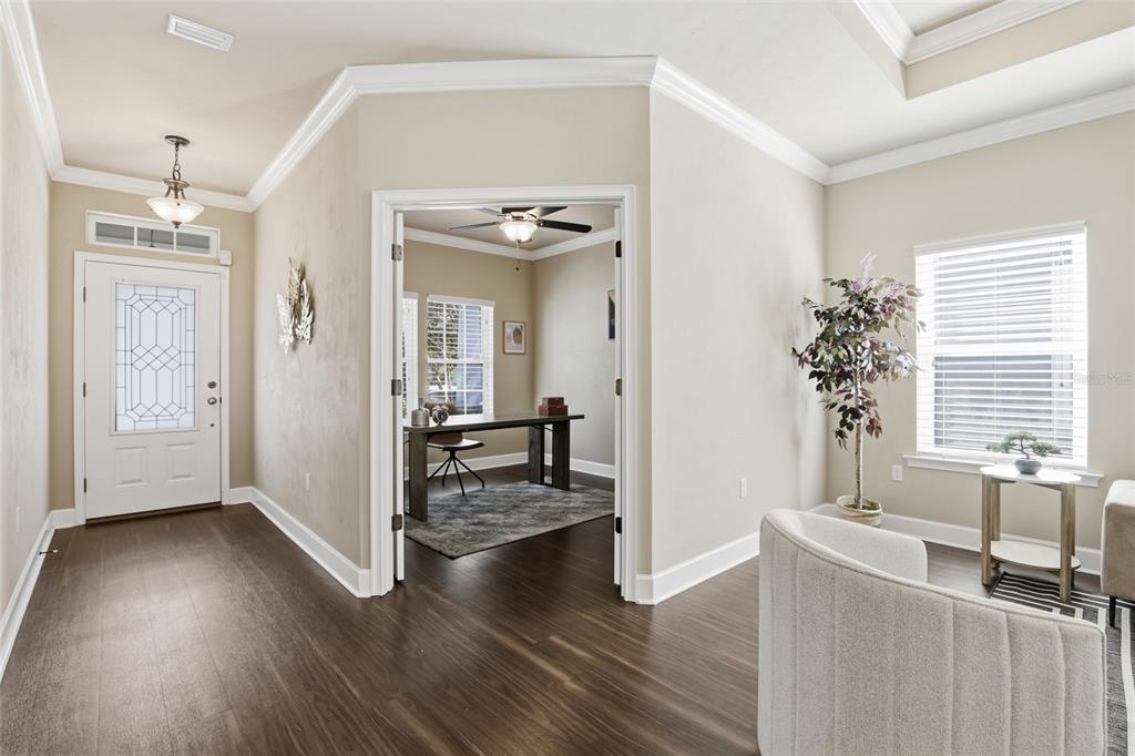 7894 Southwest 80th Drive Gainesville, FL 32608 - Photo 3 of 31 a view of a livingroom with wooden floor and a hallway
