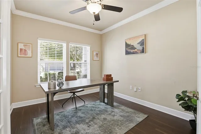 a view of a workspace with furniture and a window