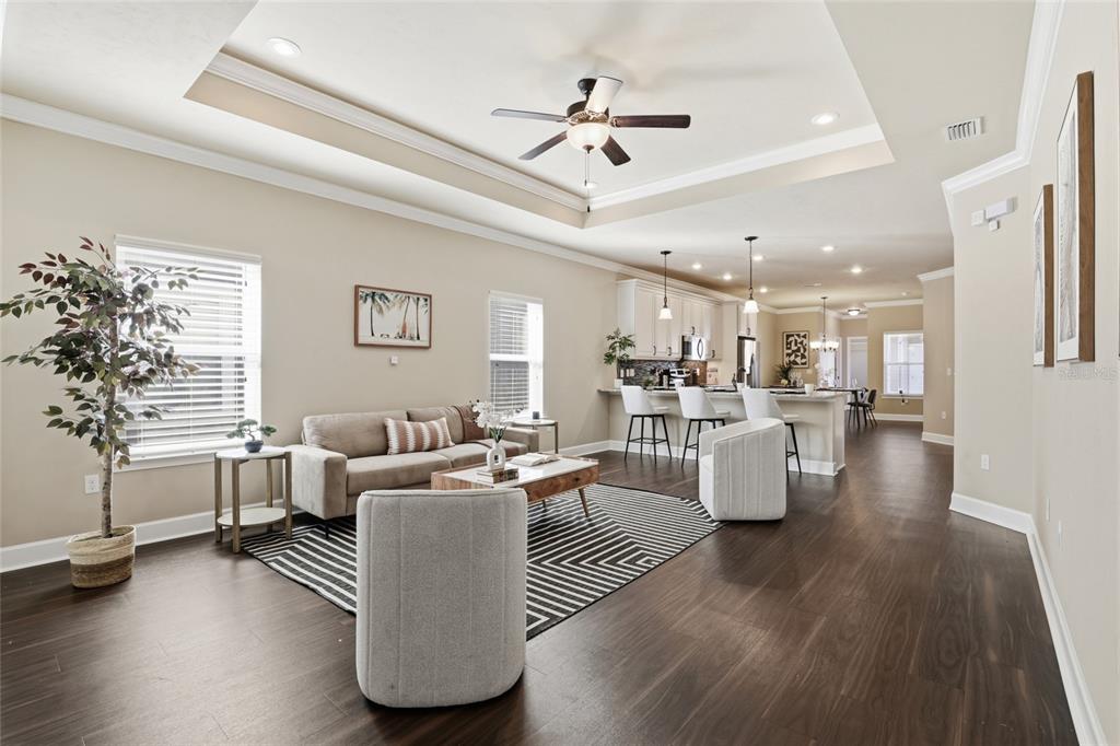 7894 Southwest 80th Drive Gainesville, FL 32608 - Photo 7 of 31 a living room with couches and kitchen view with wooden floor