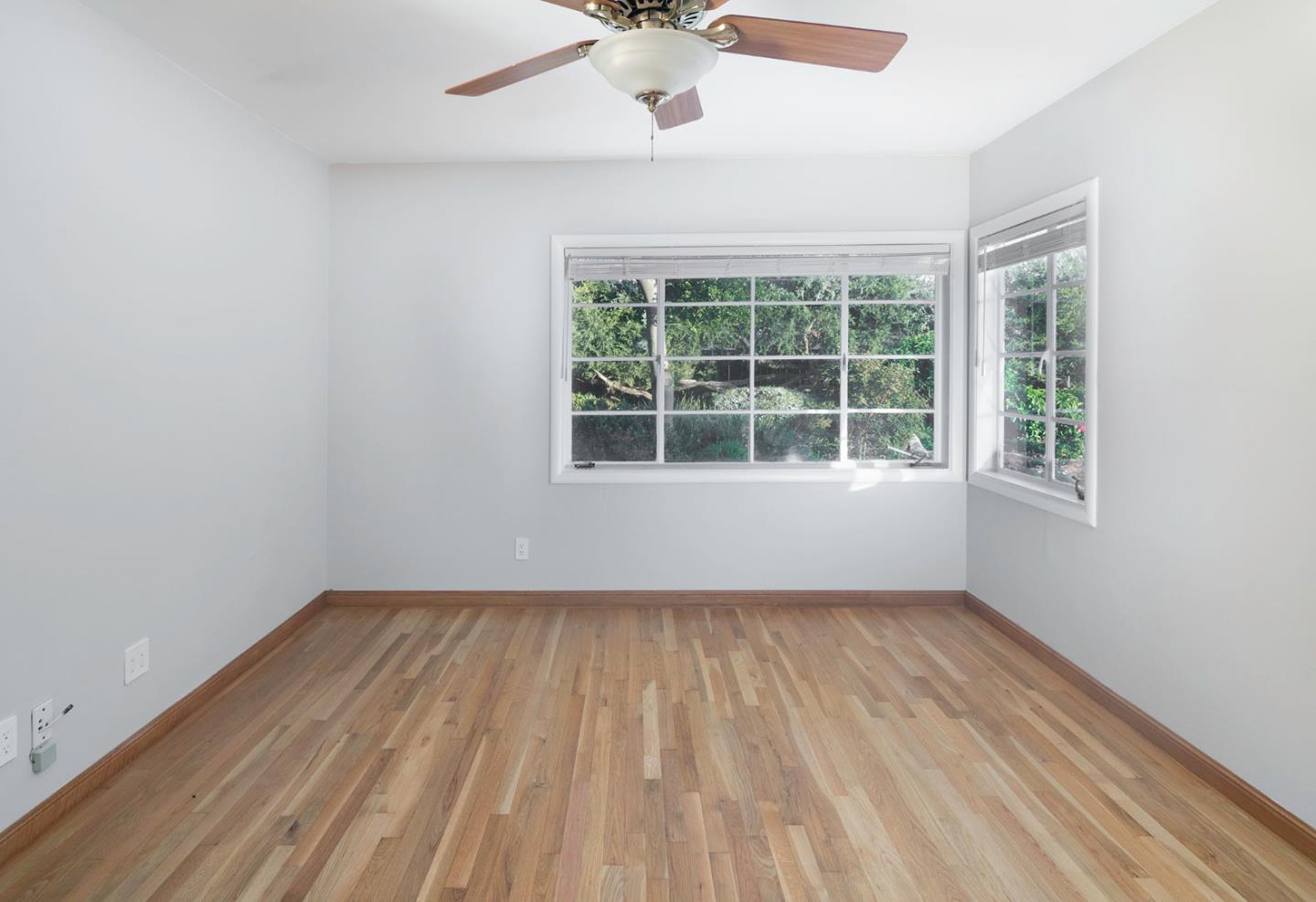 479 Riverside Road Watsonville, CA 95076 - Photo 15 of 22 an empty room with wooden floor and windows