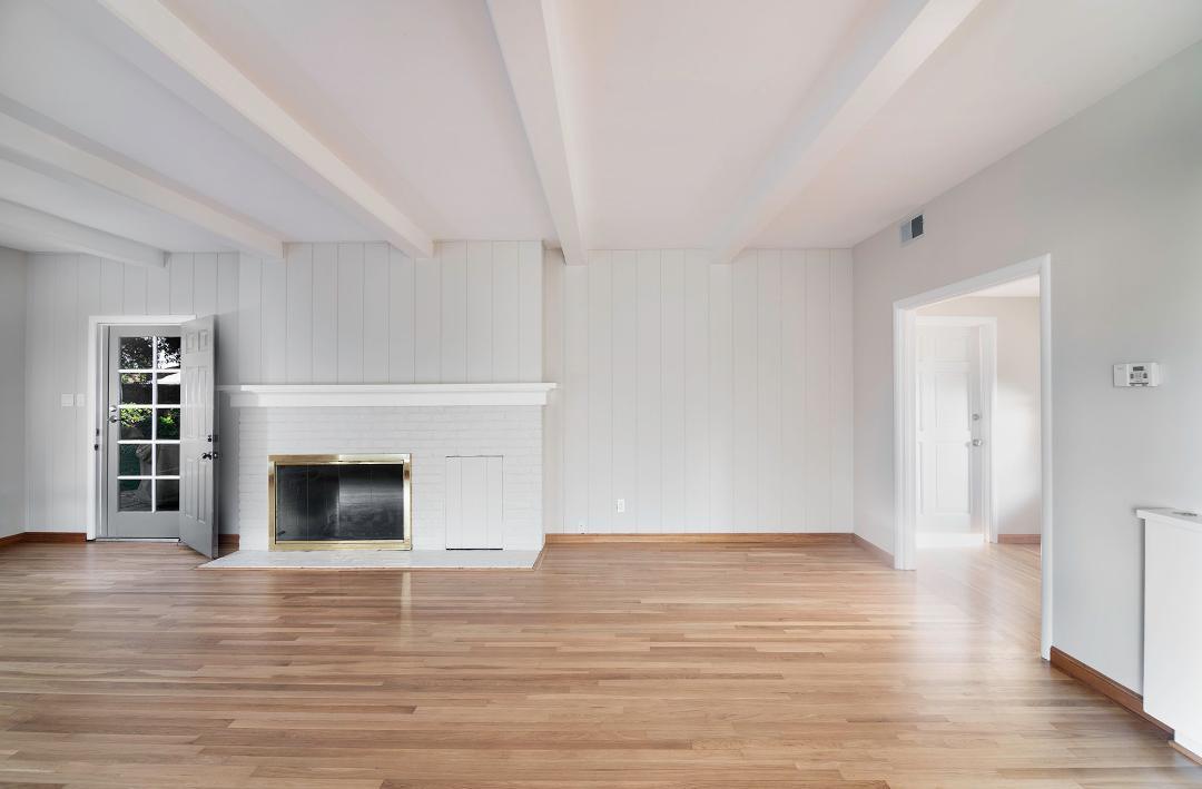 479 Riverside Road Watsonville, CA 95076 - Photo 6 of 22 a view of an empty room with wooden floor fireplace and a window