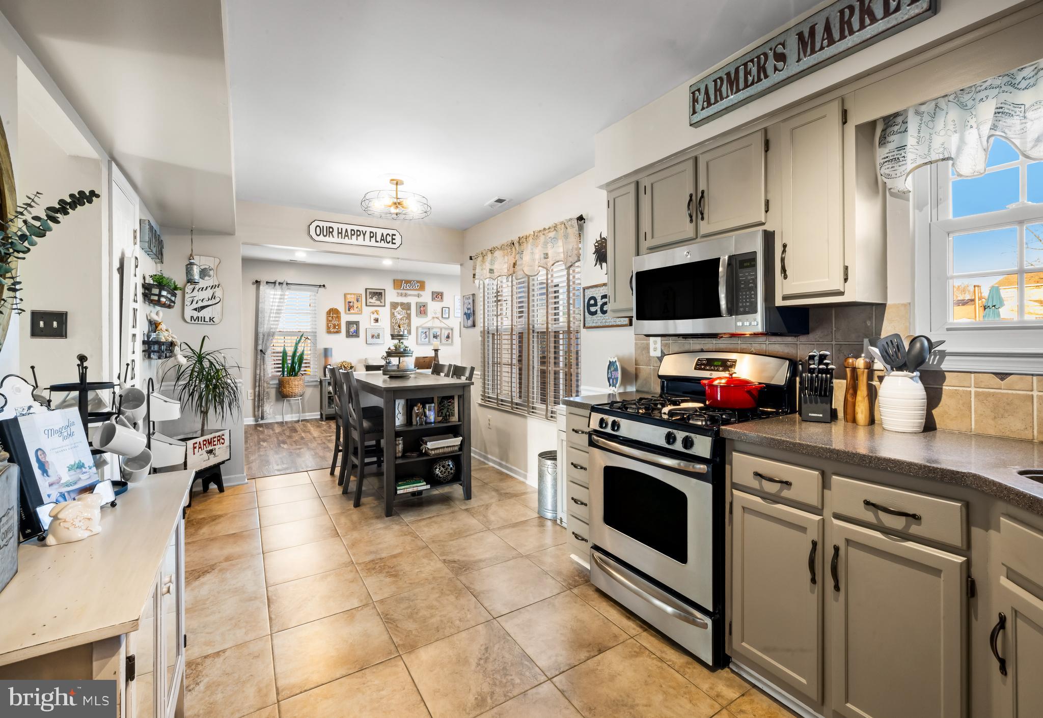 34 Borrelly Boulevard Sewell, NJ 08080 - Photo 6 of 23 a kitchen with stainless steel appliances a stove a sink cabinets and a dining table