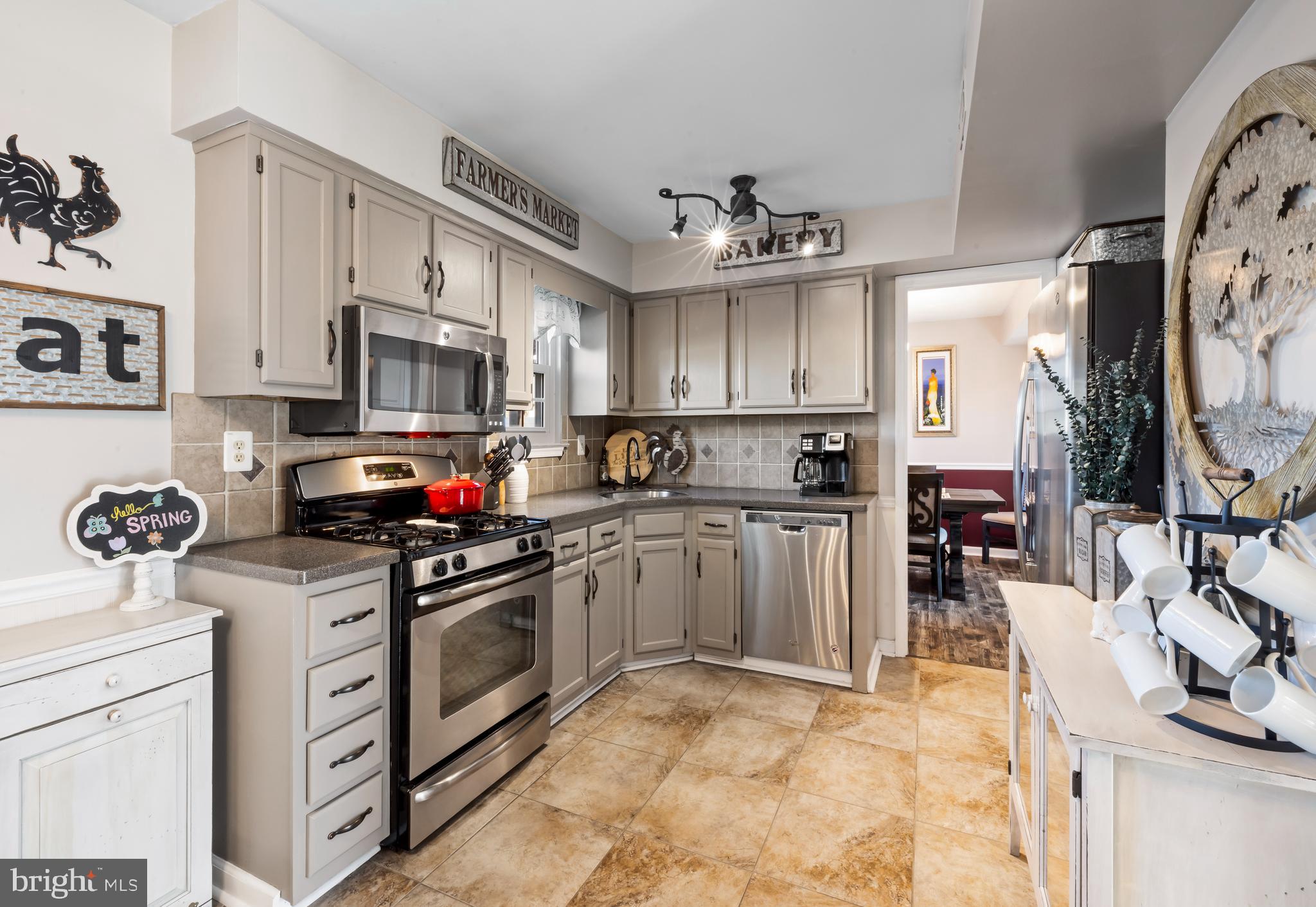 34 Borrelly Boulevard Sewell, NJ 08080 - Photo 8 of 23 a kitchen with stainless steel appliances granite countertop a sink dishwasher stove and refrigerator with wooden cabinets
